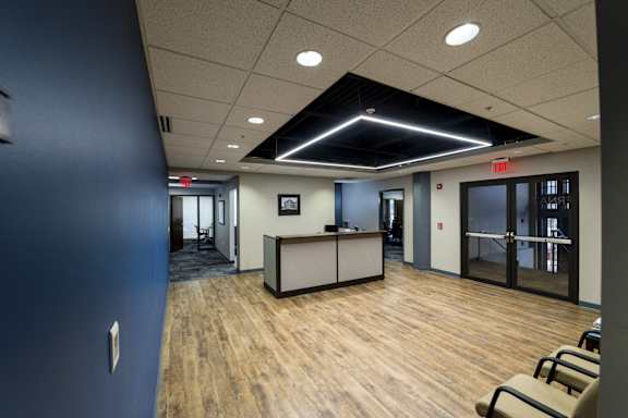 a large room with a desk and chairs in a lobby at 100 South Apartments, NY 14202
