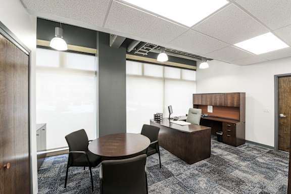 a conference room with a table and chairs and a desk at 100 South Apartments, New York 14202