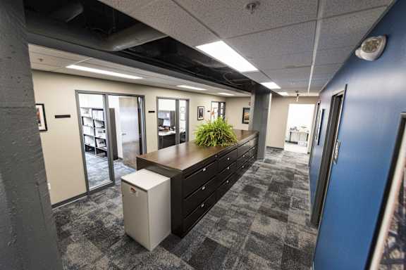 a view of an office area with a desk and a filing cabinet at 100 South Apartments, Buffalo, New York