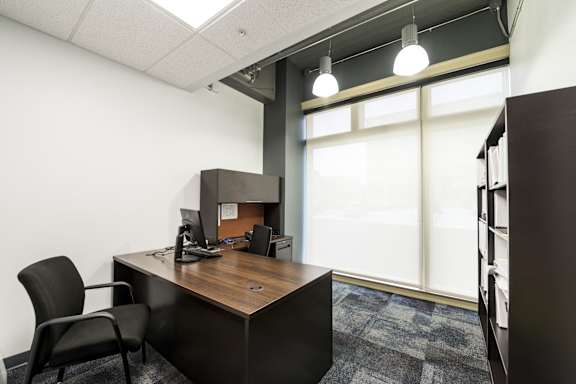 an office with a desk and a window at 100 South Apartments, Buffalo, New York 14202