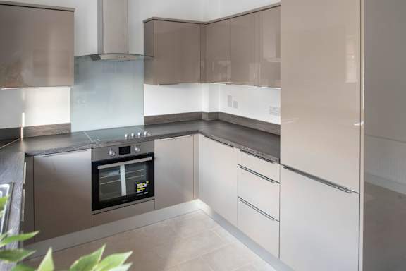 a modern kitchen with white cabinets and stainless steel appliances