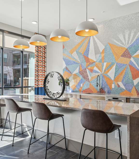 A room with orange chairs and a ceiling fan.