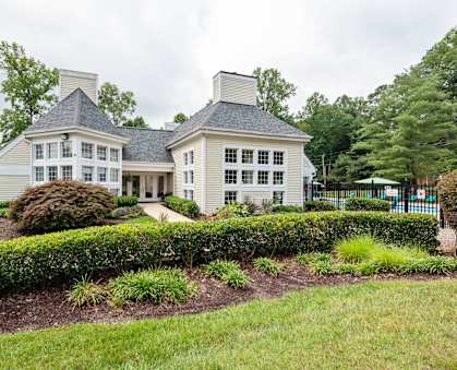 a house with a lawn and a hedge in front of it at Ashton Creek in Chester, VA 23831