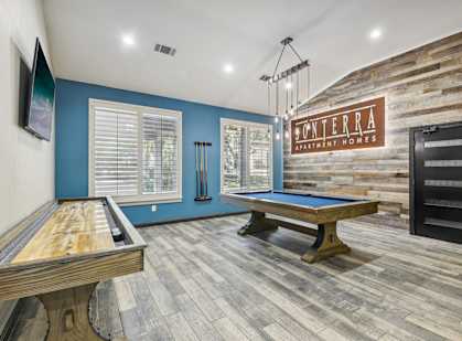 A room with a pool table and a sign that says "Monterra".