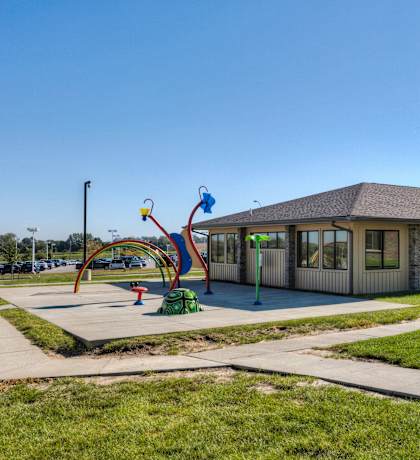 A playground with a slide at Cedarbrooke Place , Norwalk, Iowa