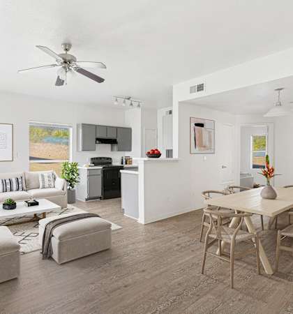 Bright open-concept living space with modern furnishings, wood-style flooring, and a neutral color palette.