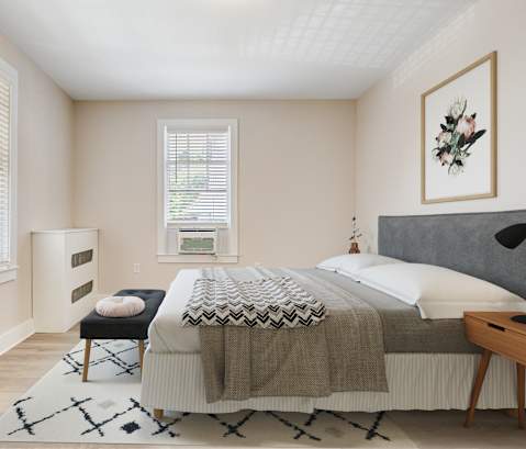 a bedroom with a bed and two windows