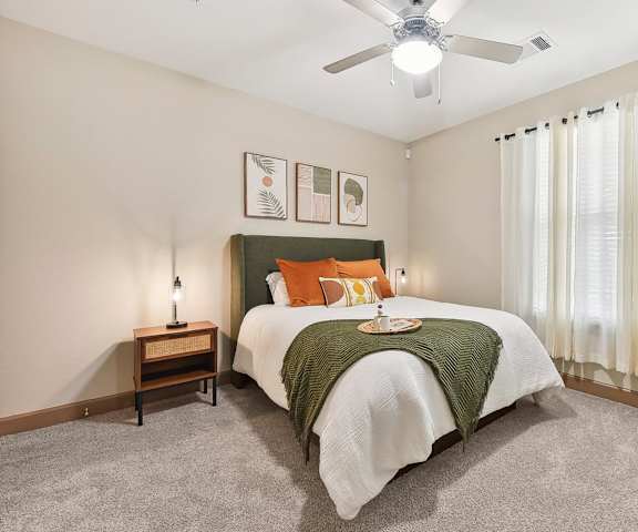 a bedroom with a bed and a ceiling fan at Lakeline East Apartments, Texas, 78613