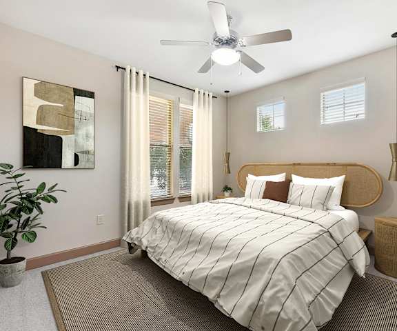 a bedroom with a large bed and a ceiling fan at Lakeline East Apartments, Cedar Park, TX