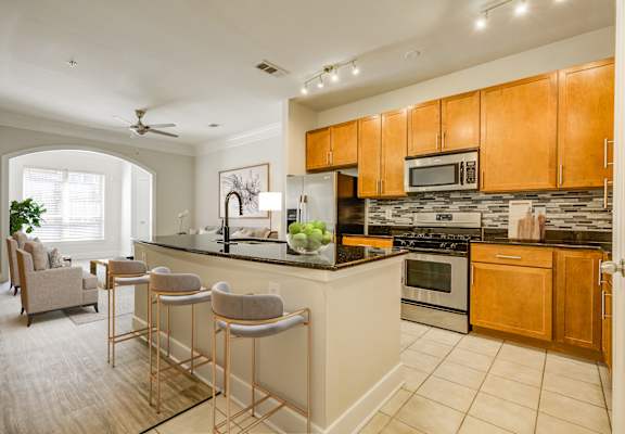 A kitchen with a bar area and a dining area.