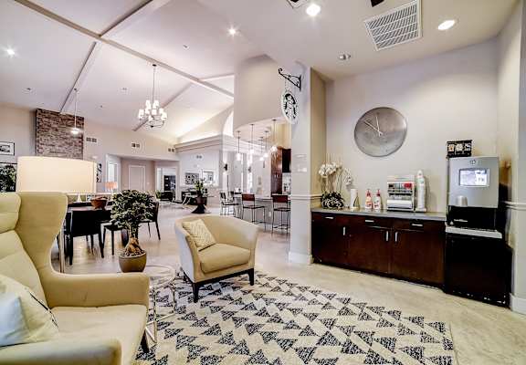 a lobby with couches and chairs and a coffee bar