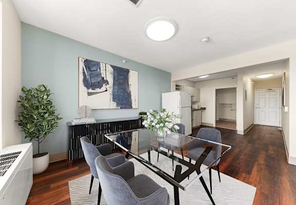 A modern dining room with a glass table and grey chairs at 206 Flats, Spokane, WA 99201