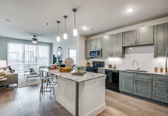 A modern kitchen with a large island in the center.