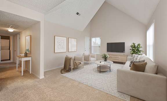 the living room of an apartment with a couch and a tv