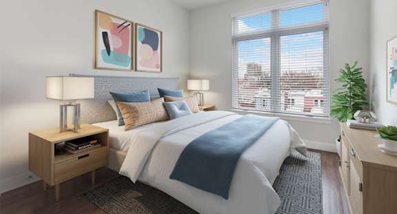 A bedroom with a large bed and a window overlooking a cityscape.