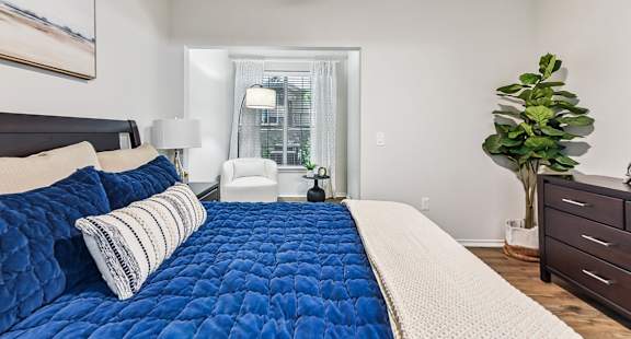 A bedroom with a large bed and a ceiling fan. at Stone Oak @ Parmer, Austin, 78727