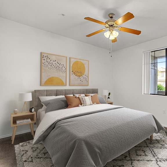 A bedroom with a bed, a ceiling fan, and a window.