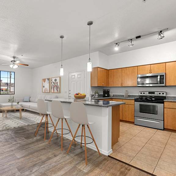 A kitchen with a dining table and chairs in the middle of the room.