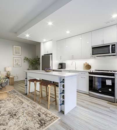 a living area with a kitchen and a couch