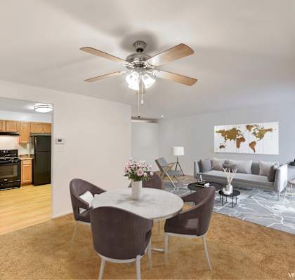 a living room with a ceiling fan and a table and chairs at The Forest, Rockville, MD 20851
