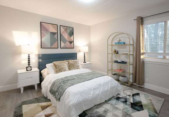 A bedroom with a white bed and a blue headboard.