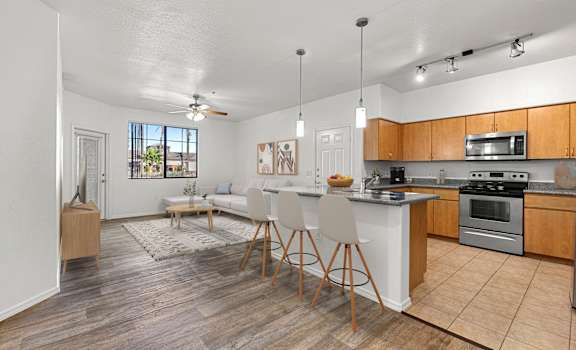 A kitchen with a dining table and chairs in the middle of the room.