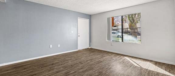 Empty room with wooden floor and white walls.