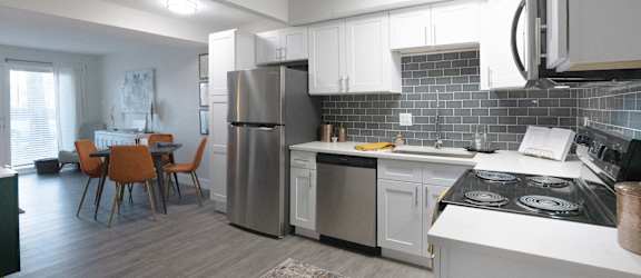 A modern kitchen with a dining table and chairs.
