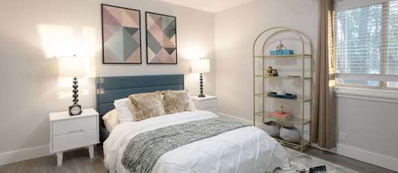 A bedroom with a white bed and a blue headboard.