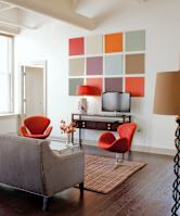 a living room with a couch and chairs and a television at 100 South Apartments, Buffalo, NY