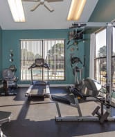 a gym with exercise equipment and a window