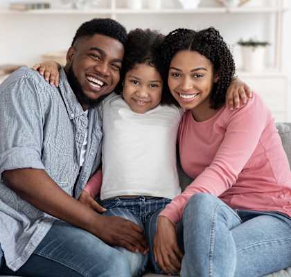 a family sitting on a couch