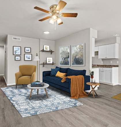 a living room with a blue couch and a ceiling fan
