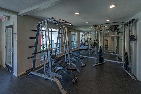 A gym with a variety of equipment including a leg press machine.