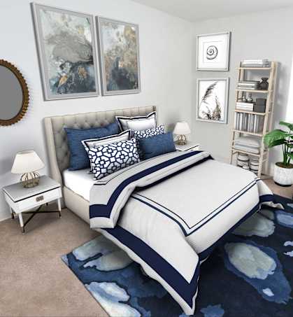 a bedroom with blue and white bedding and a blue rug