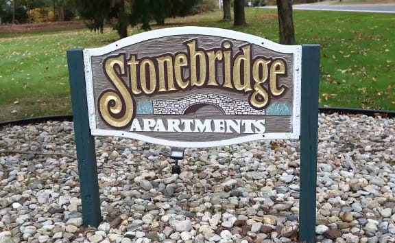 a sign for stonebridge apartments in a park at Stonebridge, Ellington, Connecticut