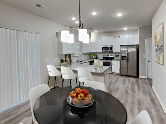 an open kitchen and dining room with a table and chairs