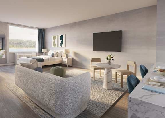 Rendering of a living room with a couch and a table at Hudson Piers, Yonkers