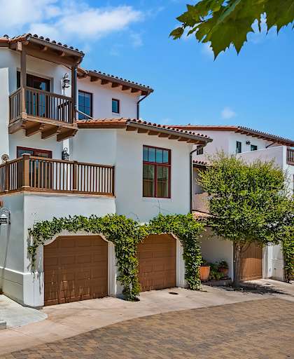 a white house with a garage and a driveway