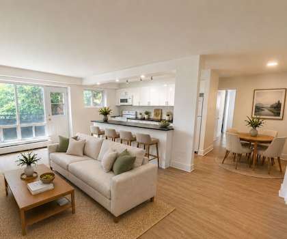 A living room with a white couch and a wooden coffee table.