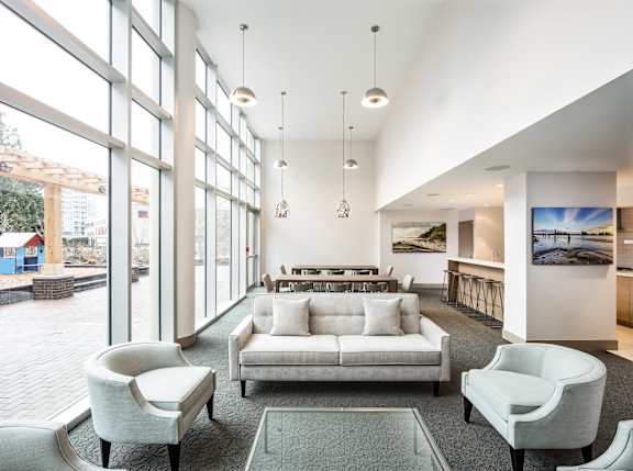 A modern living room with a large window overlooking a playground.