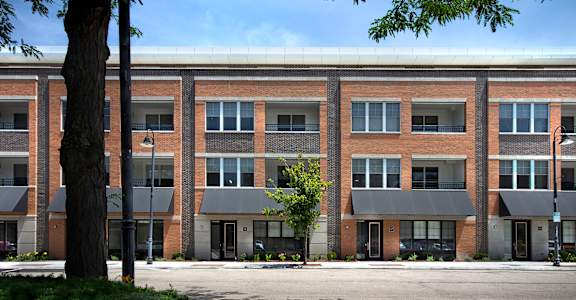 a large brick building with a street in front of it