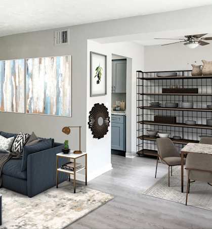 a living room with a blue couch and a dining room table