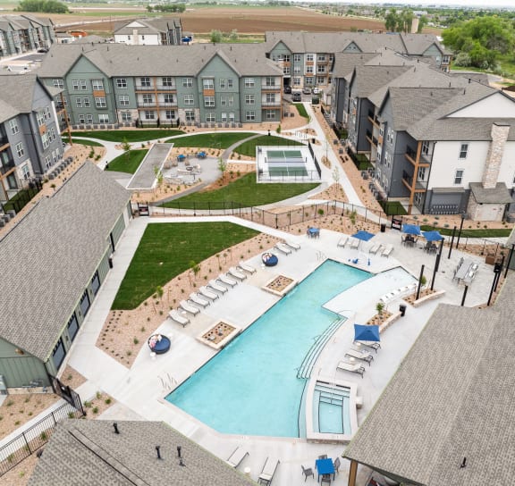 an aerial view of the resort style pool with lounge chairs and umbrellas at Notch66, Colorado, 80504