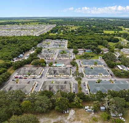 an aerial view of an empty parking lot in a city at The Groves at Wimauma Apartments , Wimauma