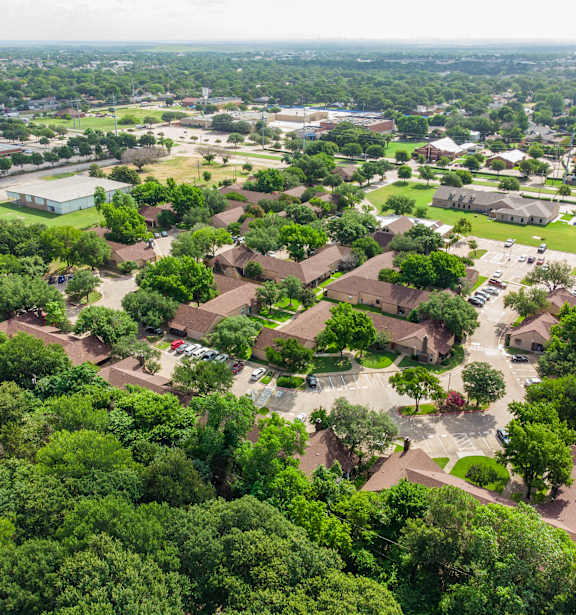 A bird's eye view of a residential area with houses and trees.