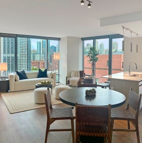 a living room and dining room with a view of the city at Cassidy on Canal, Chicago, IL