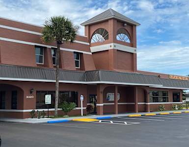 a building with a clock tower on top of it at Colonial Apartments, Orlando, 32808