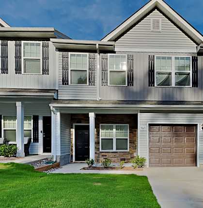 a house with a garage door and a car parked in front of it
