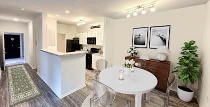 A modern kitchen with a dining table and chairs.